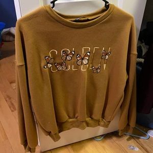 Harry Styles golden sweater
